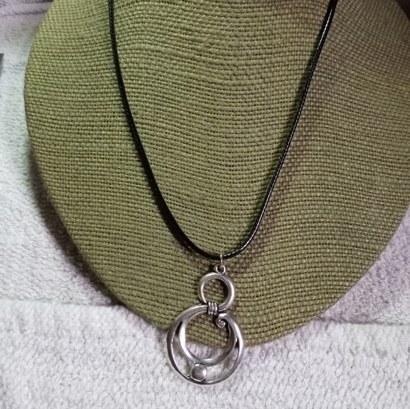 Vintage Jewelry - Silvertone swirl necklace on black cord